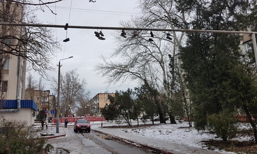 Новая традиция? В Керчи на трубу над дорогой закидывают кроссовки